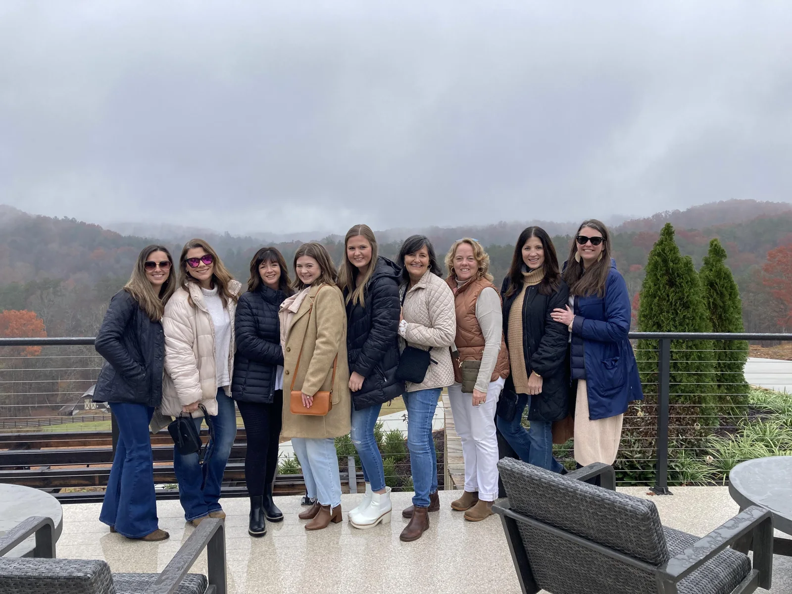 A group of friends on a winery terrace overlooking the mountains