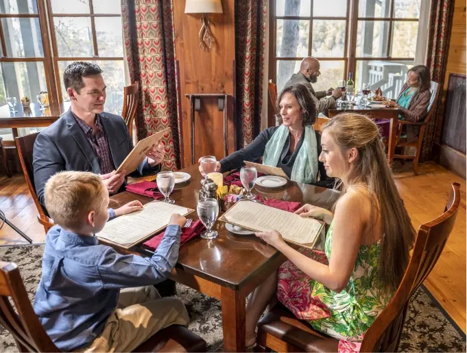 Guests dining beside mountain-view windows at Brasstown Valley Resort
