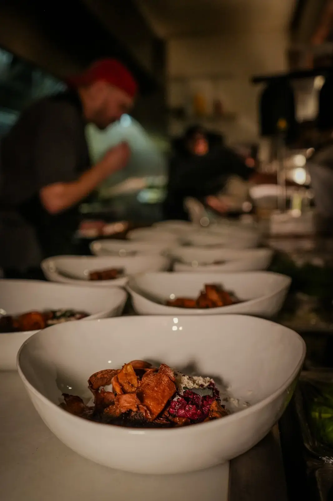 Chefs plating bowls in the Table 20 kitchen in Cartersville
