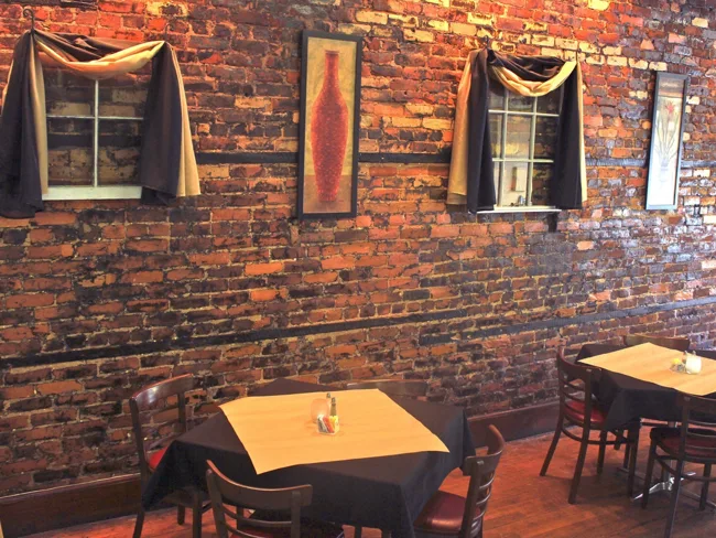 Exposed-brick dining space at X-Factor Grill