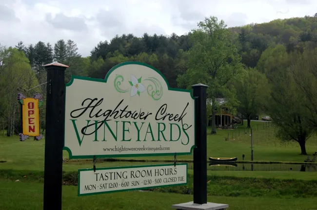 Hightower Creek Vineyards entrance sign with vines and wooded hills