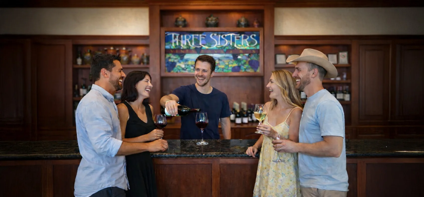Guests tasting wine at the Three Sisters tasting-room bar