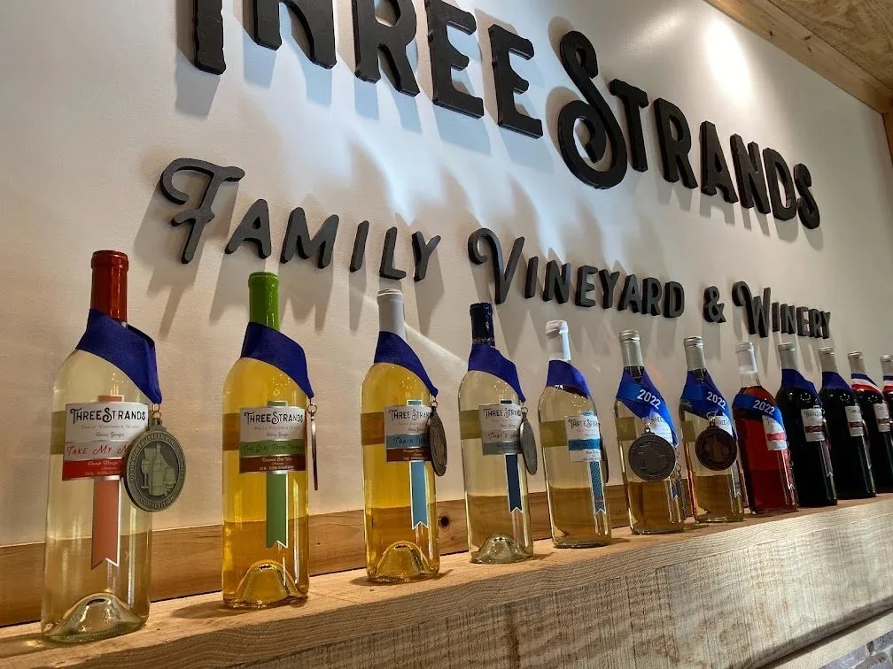 Three Strands estate wines displayed in the tasting room