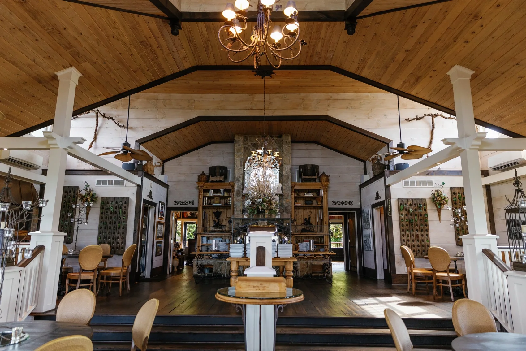 Stone fireplace and tasting-room seating at Wolf Mountain